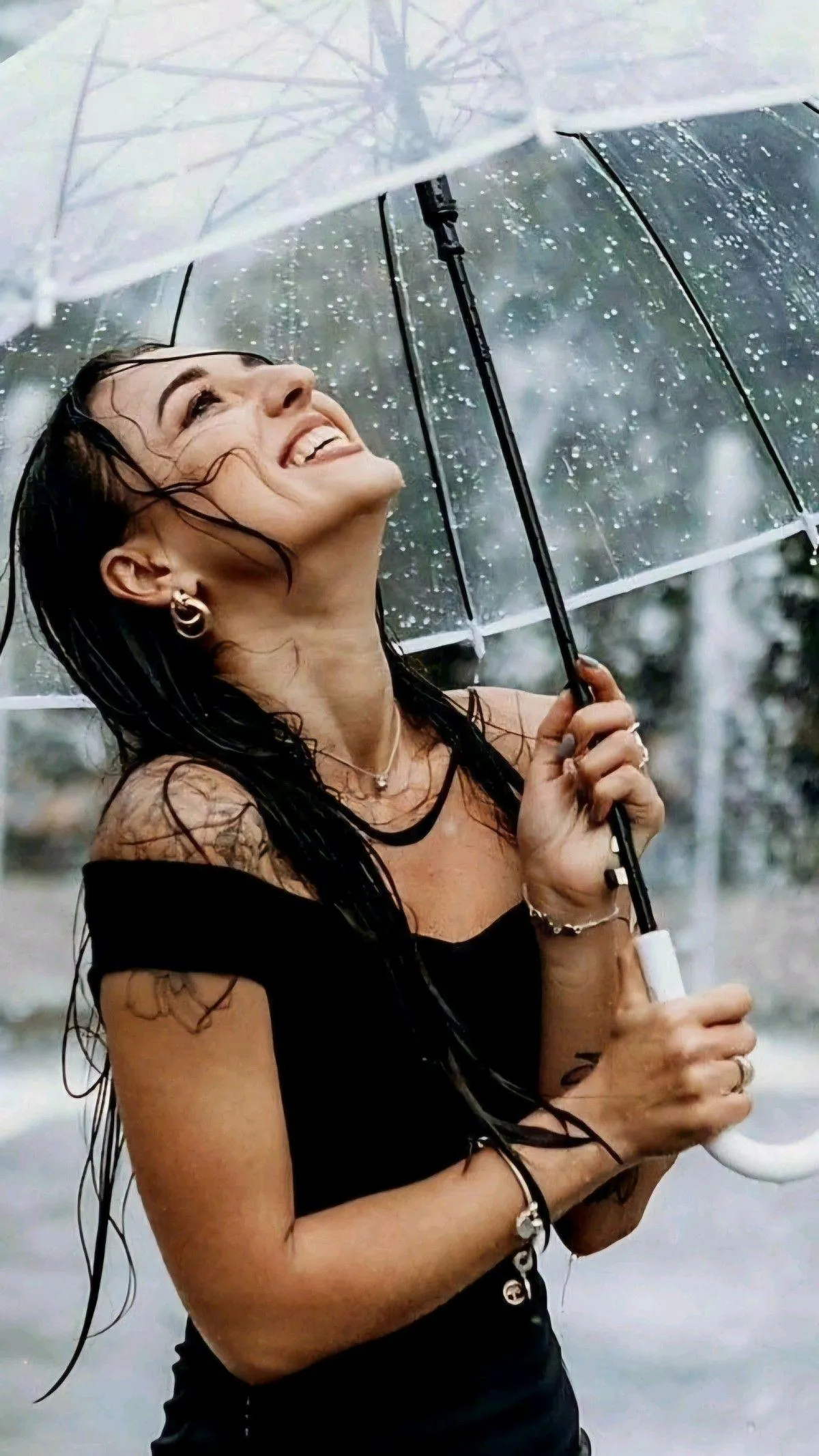 Woman Laughing Under an Umbrella on a Rainy Day Wallpaper