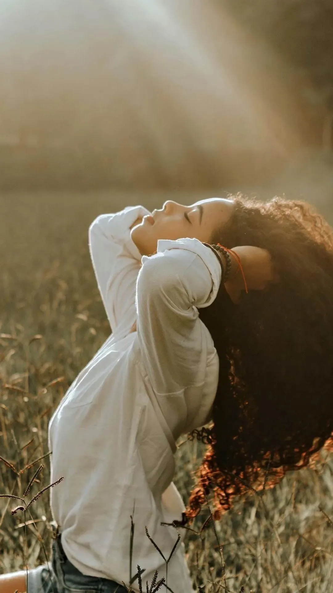 Woman with Leaf Shadows on Face in Autumn Sunlight Wallpaper