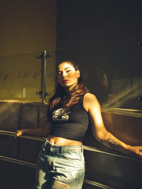 Woman Leaning on a Railing in an Urban Nighttime Setting