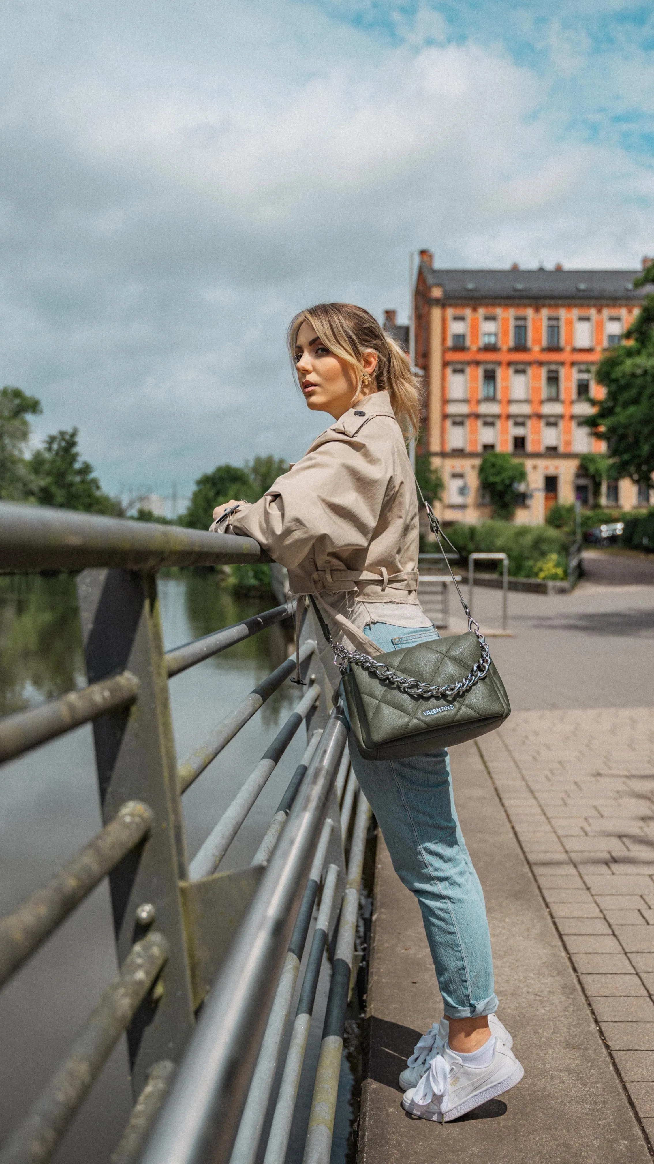 Woman Leaning on a Railing in a City Setting Outdoors