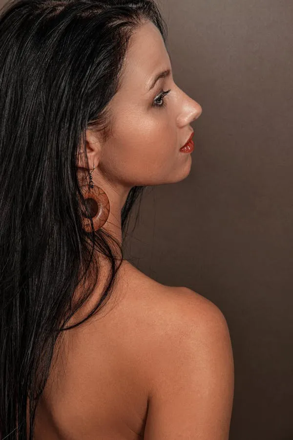 Woman with Long Black Hair Posing with Her Bare Back Exposed