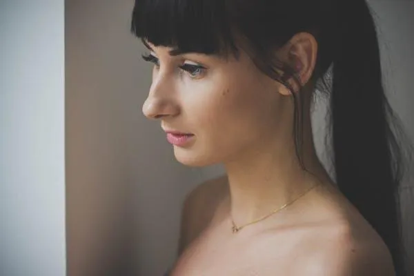 Woman Looking Out the Window with Soft Expression in Profile