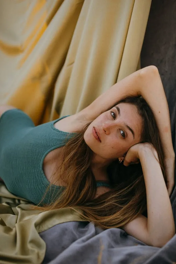 Woman Lying Down on a Couch with a Relaxed Expression Image