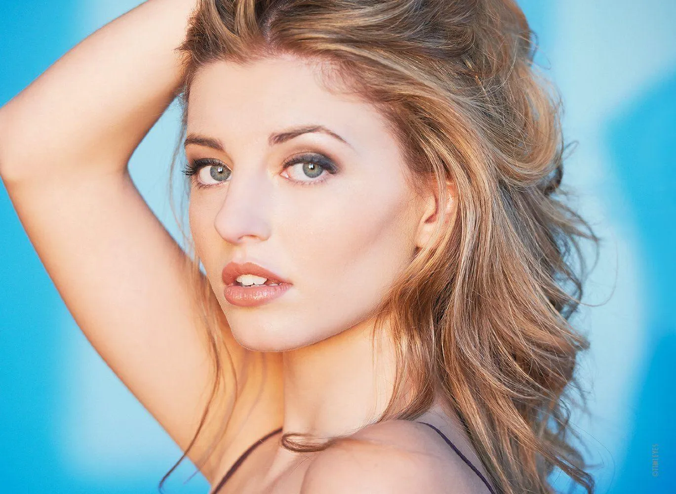 Woman Lying Upside Down with Her Hand in Her Hair on Floor