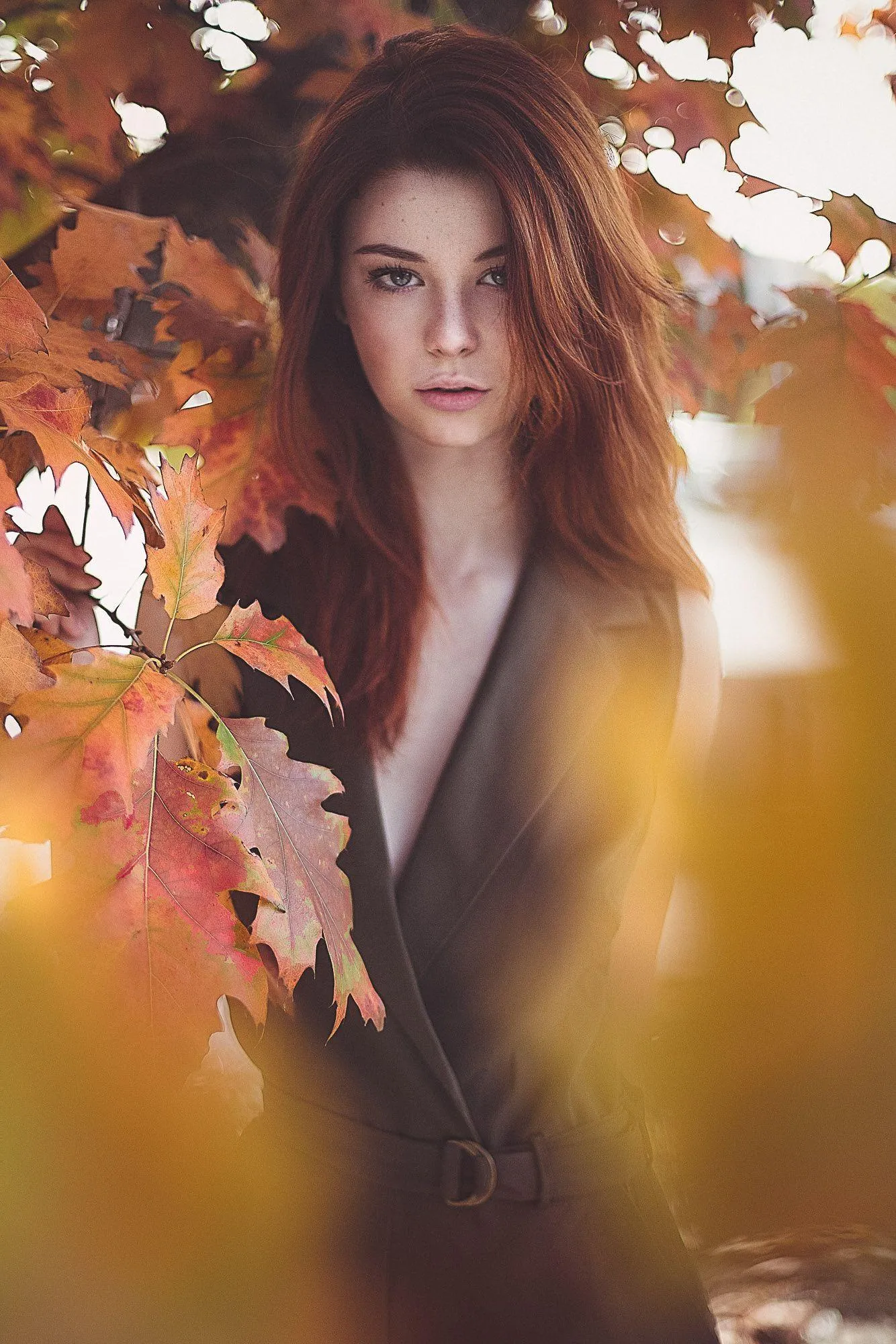 Woman Model Among Autumn Leaves Looking Pensively Wallpaper