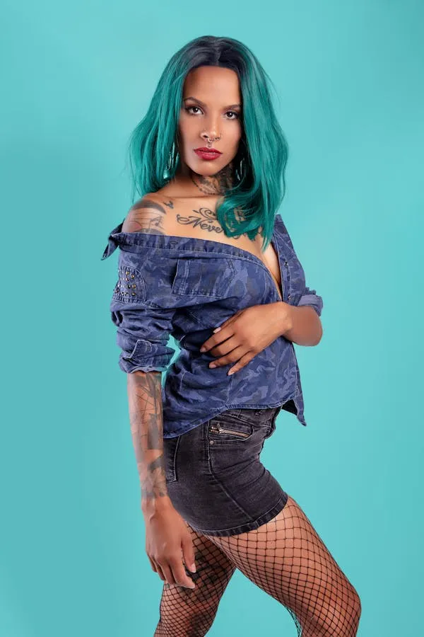 Woman Model with Teal Hair Wearing Fishnets and Denim Shorts