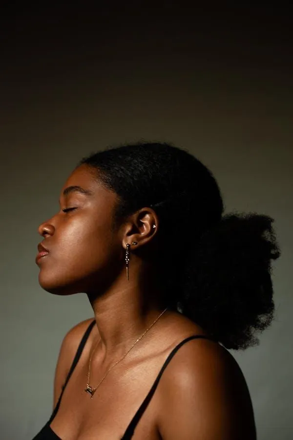 Woman with Natural Hair in Profile Against a Warm Background