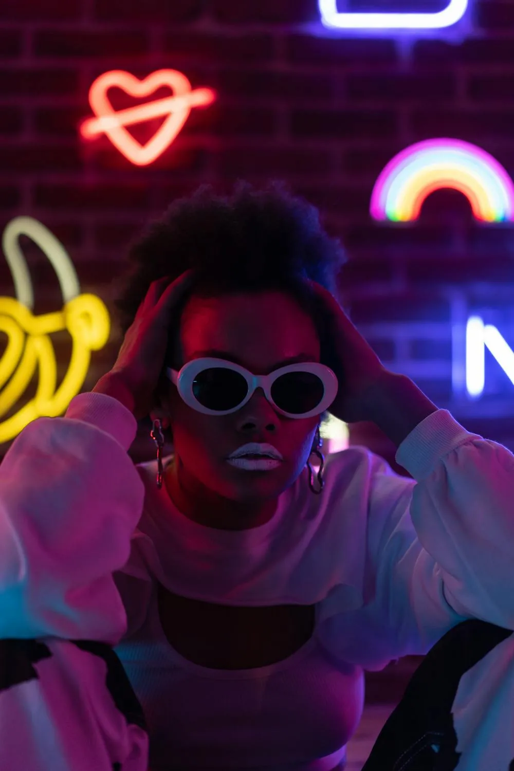 Woman in Neon Lights Wearing Sunglasses and Posing Wallpaper
