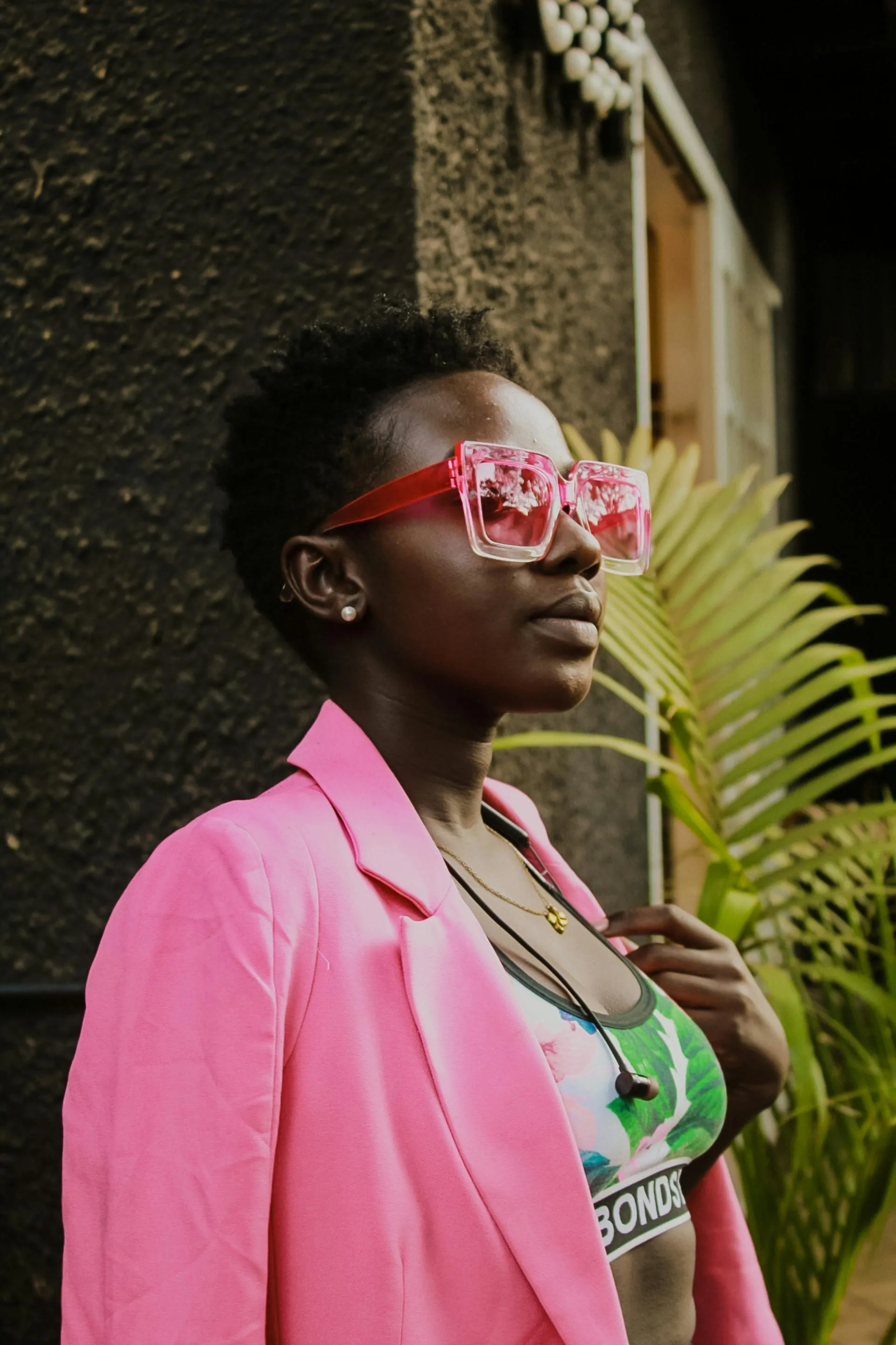 Woman in a Pink Jacket Wearing Stylish Sunglasses Outside