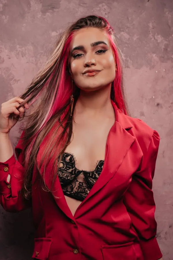 Woman with Pink Streaked Hair Wearing a Red Satin Jacket