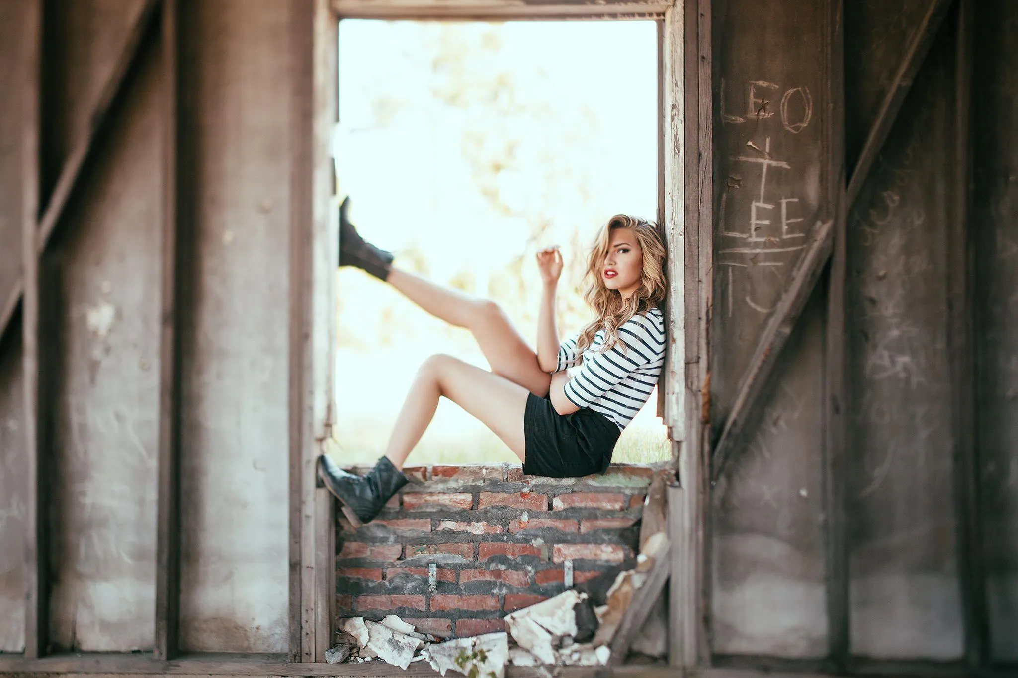Woman Posing in an Old Structure with a Rustic Background