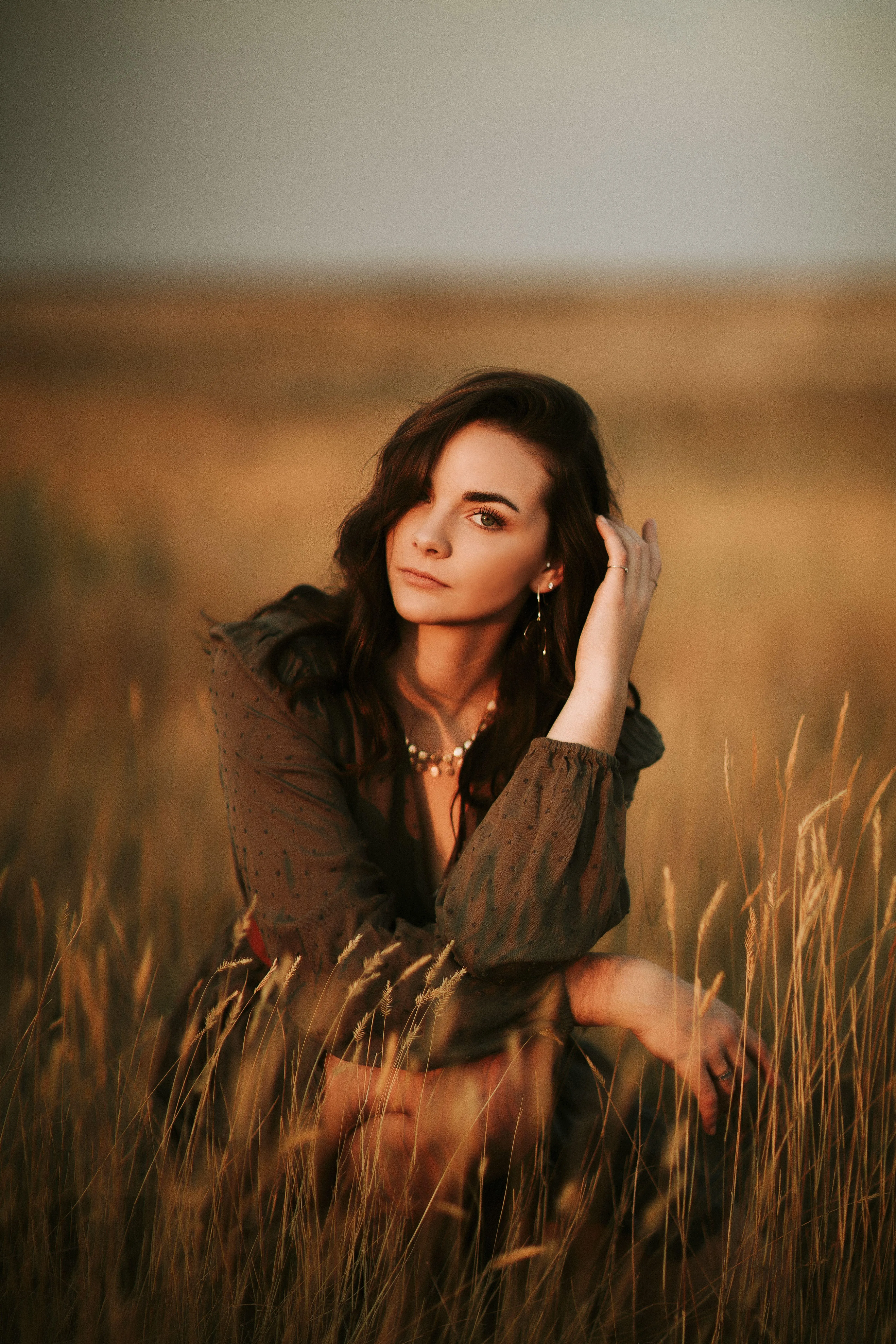 Woman Posing Calmly in a Golden Field At Sunset Hd Wallpaper