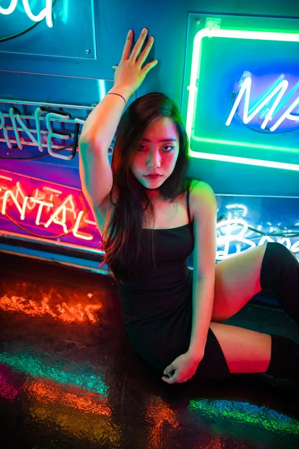 Woman Posing in Neon Lights with a Cool and Vibrant Look