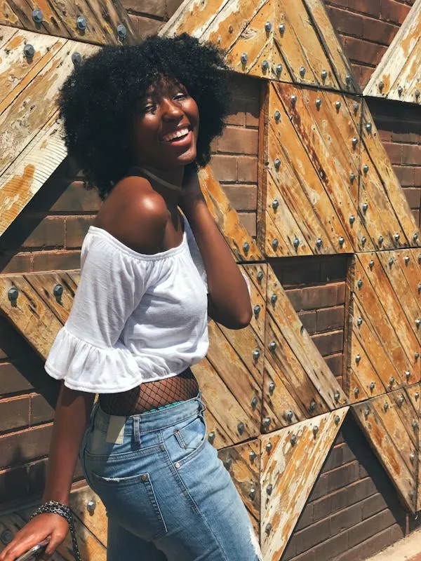 Woman Posing in White Top and Jeans with Wooden Background