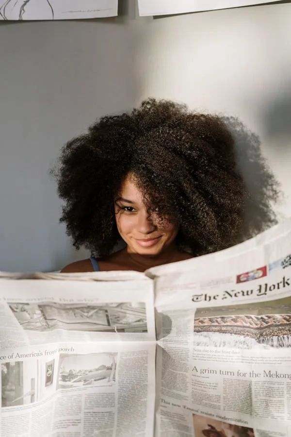Woman Reading a Newspaper with a Big Smile in a Cozy Setting