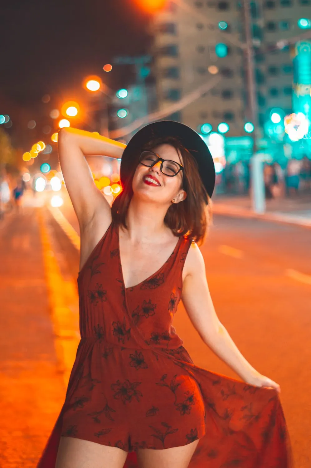 Woman in Red Dress Posing on a City Street At Night Glow