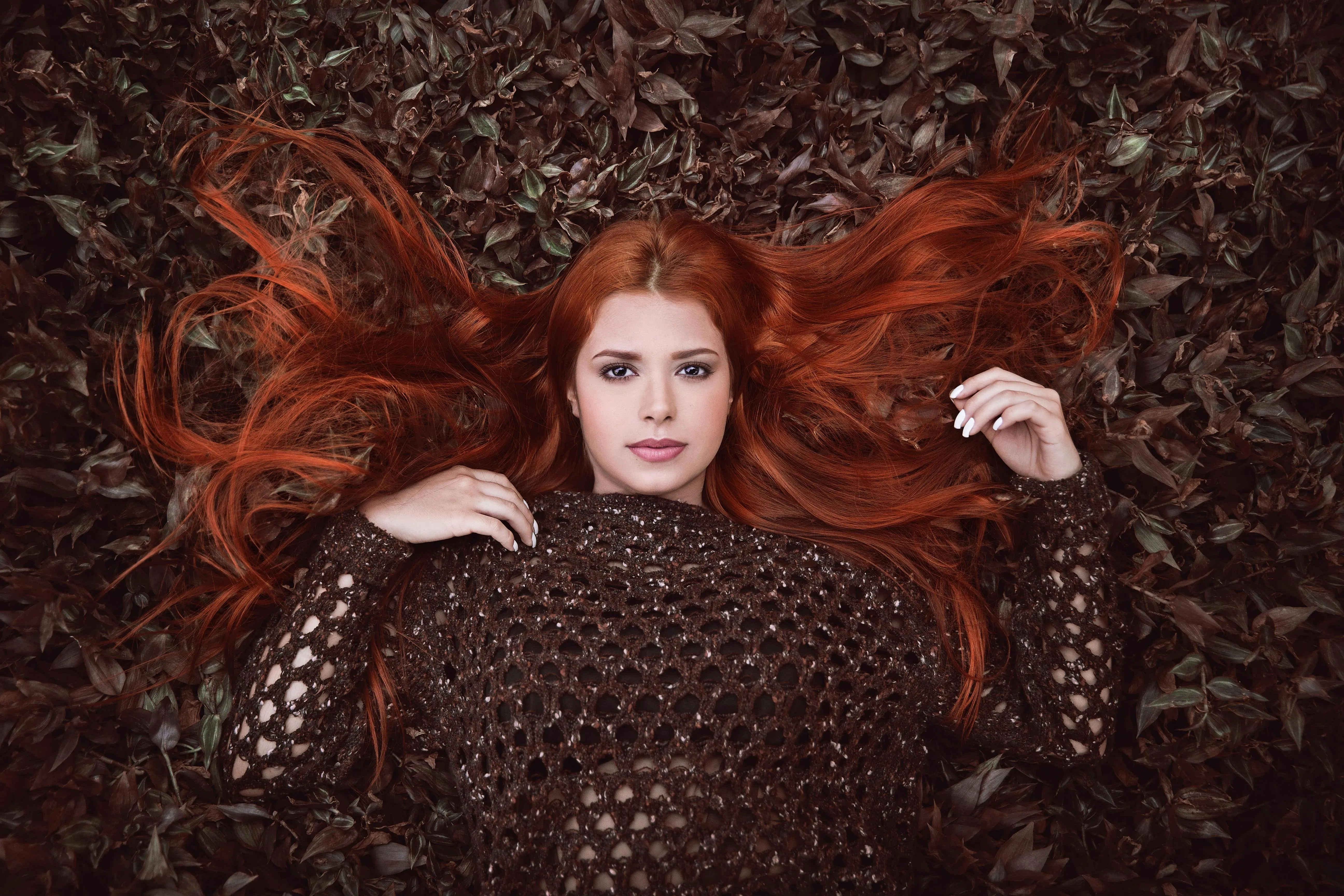 Woman with Red Hair Lying on Leaves in Autumn Free Wallpaper