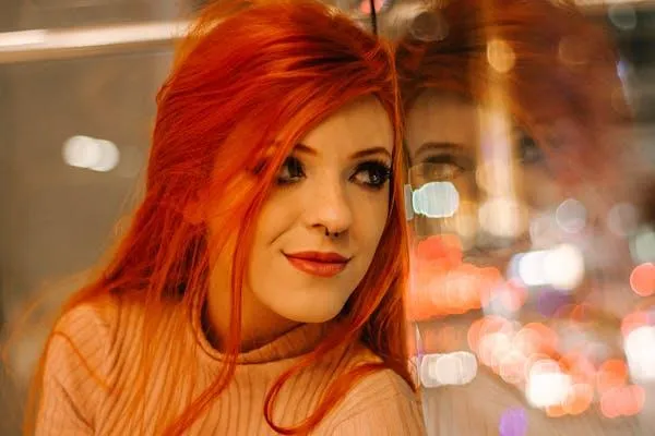 Woman with Red Hair Smiling Under City Night Lights Images