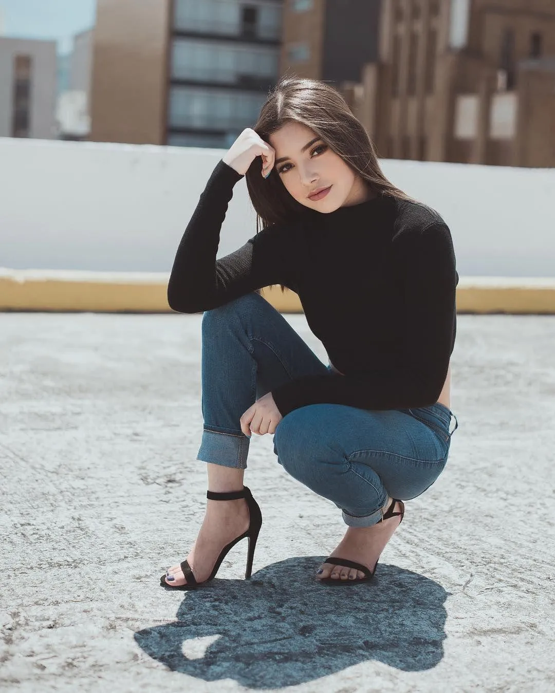 Woman in a Red Jacket Sitting on a Stone Bench Outdoors