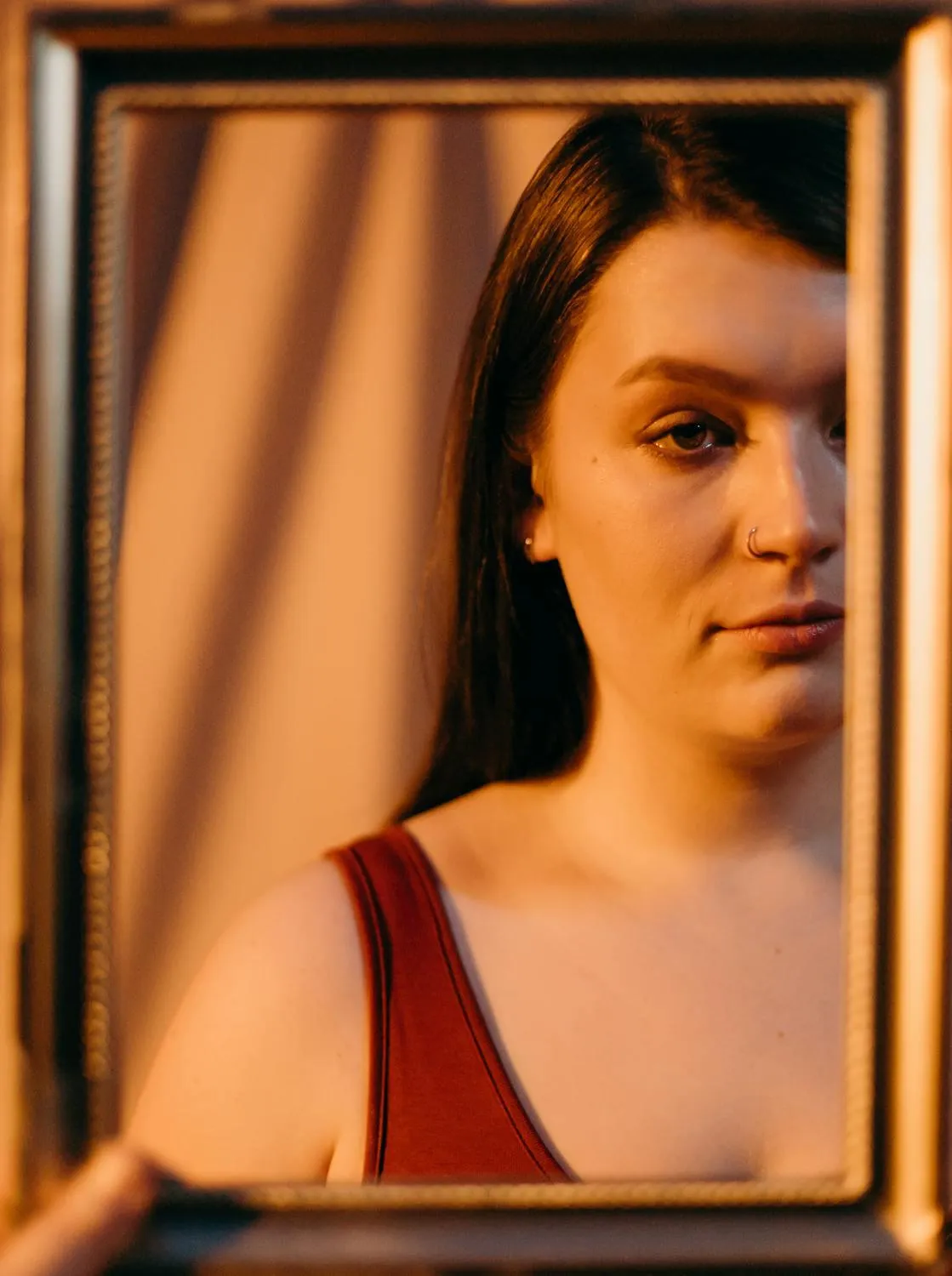 Woman in Red Top Posing with Wooden Frame As Mirror Prop