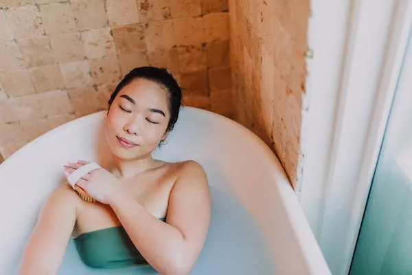 Woman Relaxing in Bathtub with Eyes Closed in Peaceful Mood