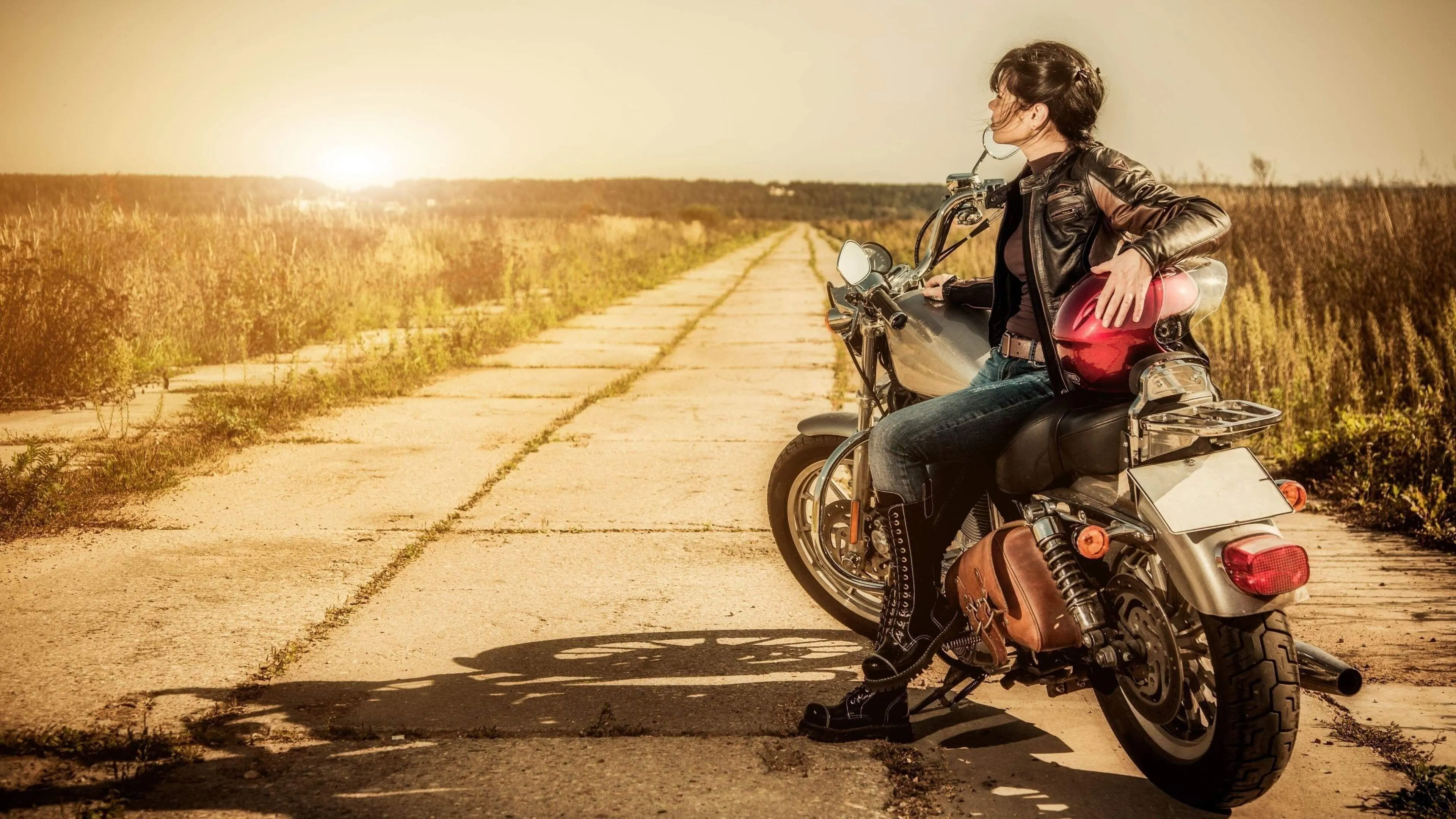 Woman Riding a Scooter Down a Rural Road in Warm Light Image