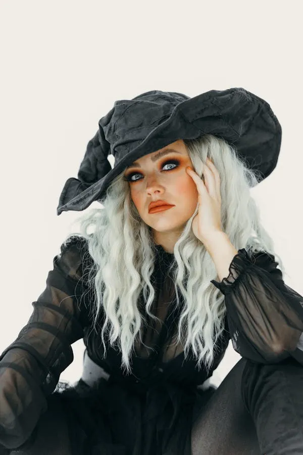 Woman with Silver Hair and Witch Hat in Black Sheer Dress