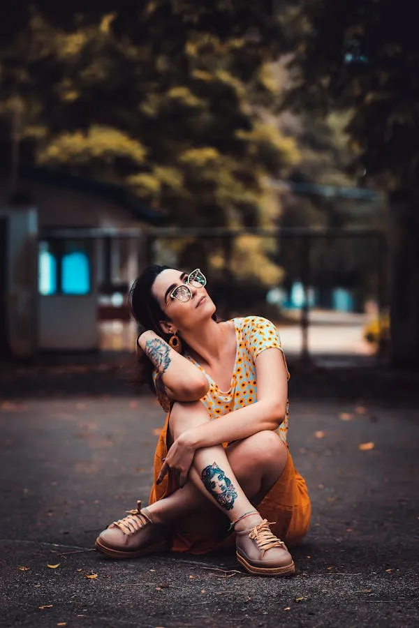 Woman Sitting Cross Legged on the Pavement with Trees Around