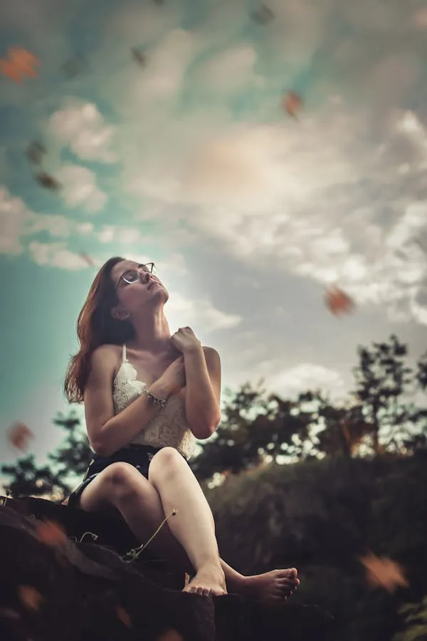 Woman Sitting Gracefully on the Ground with a Dreamy Look