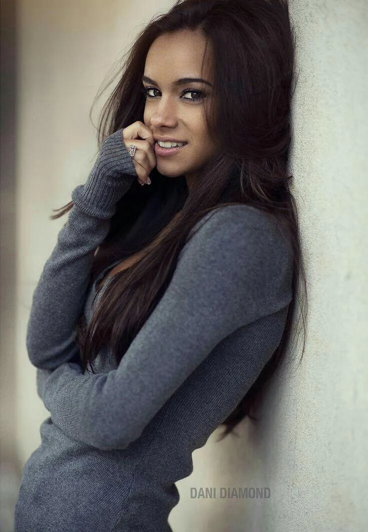 Woman Sitting Outdoors with Sunset Light Behind Her Image
