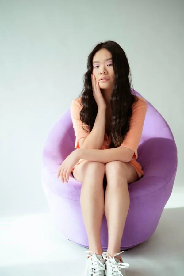 Woman Sitting in a Purple Chair Wearing a Casual Outfit