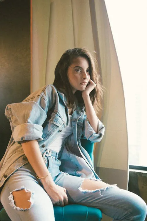 Woman Sitting by Window in Casual Denim Outfit Hd Wallpaper