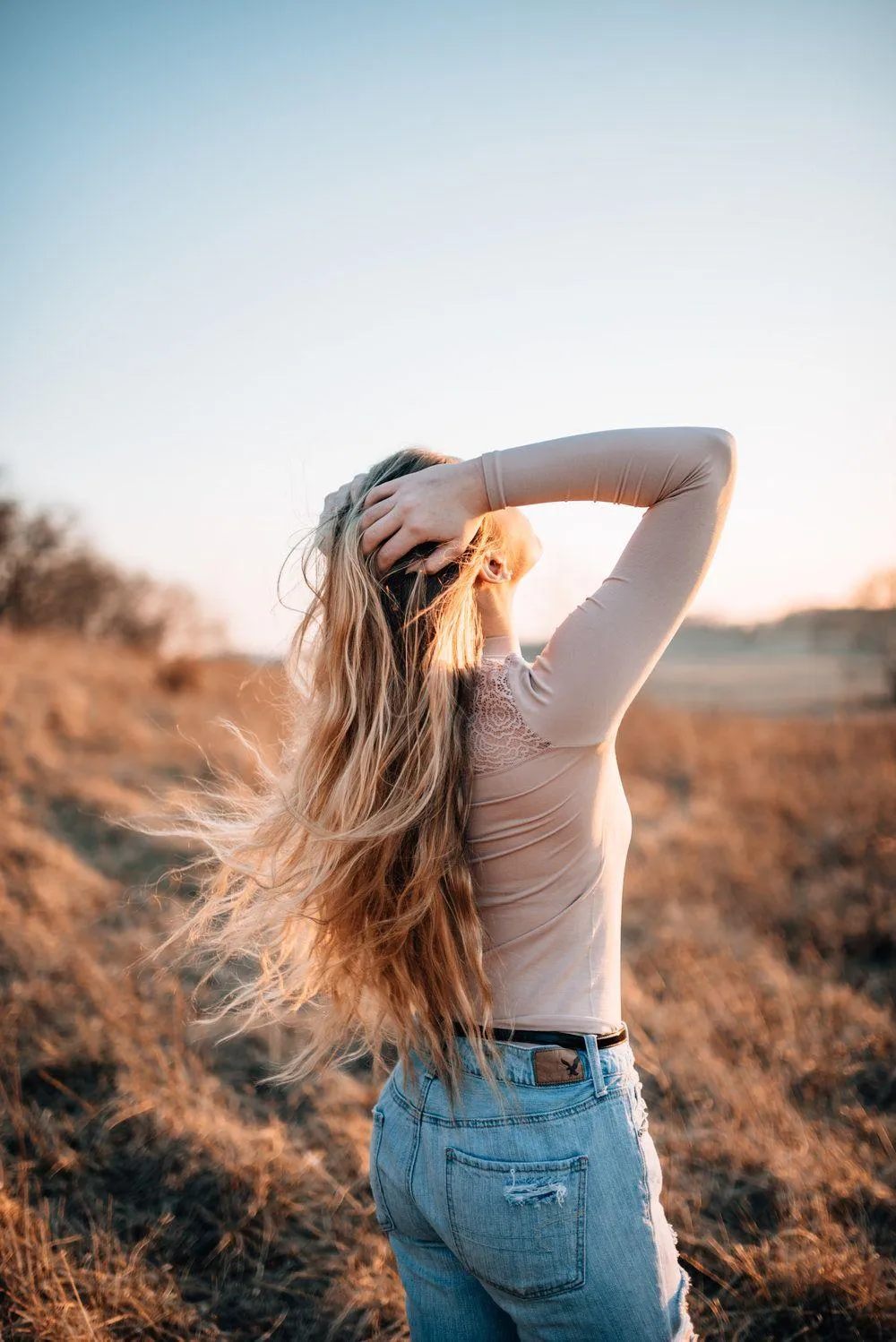 Woman Sitting on a Wooden Crate in a Cozy Rustic Living Room