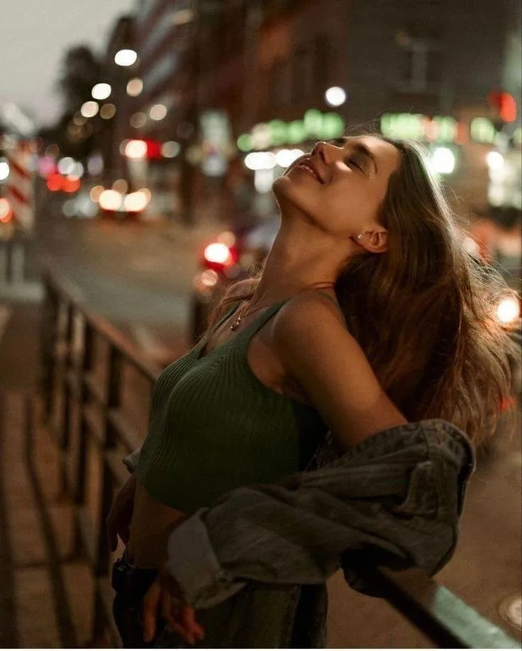 Woman Smiling and Walking Confidently on a Busy City Street