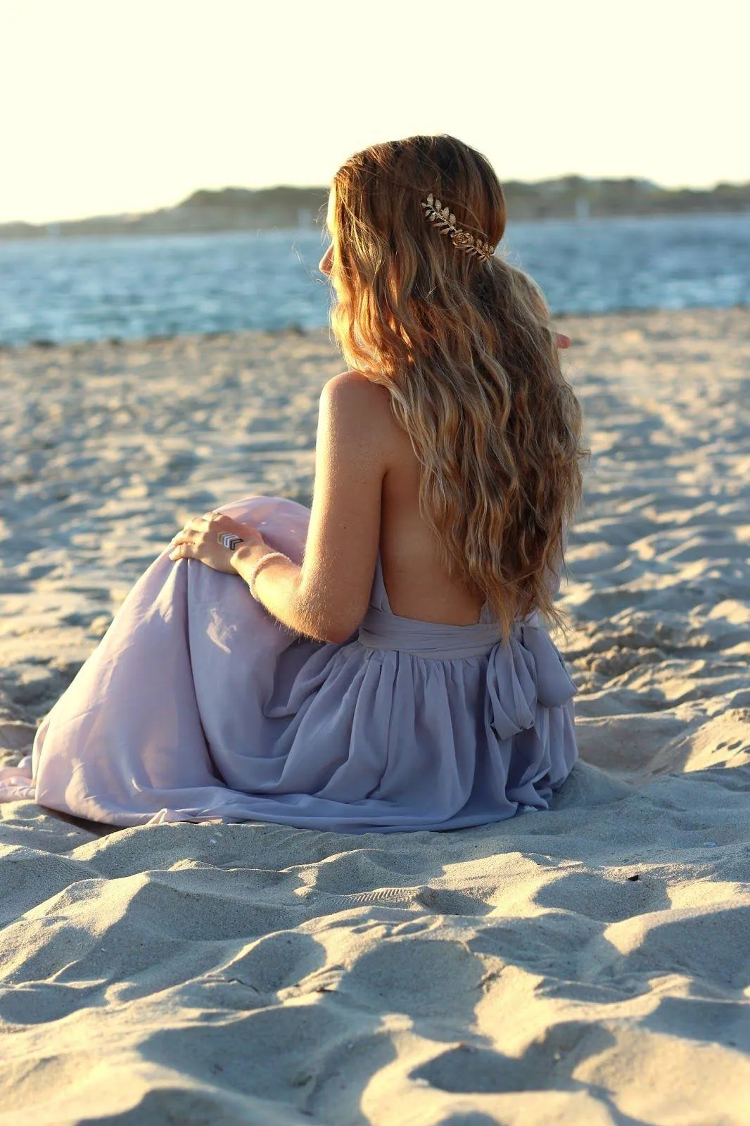 Woman in Soft Light Holding Grass with a Peaceful Expression