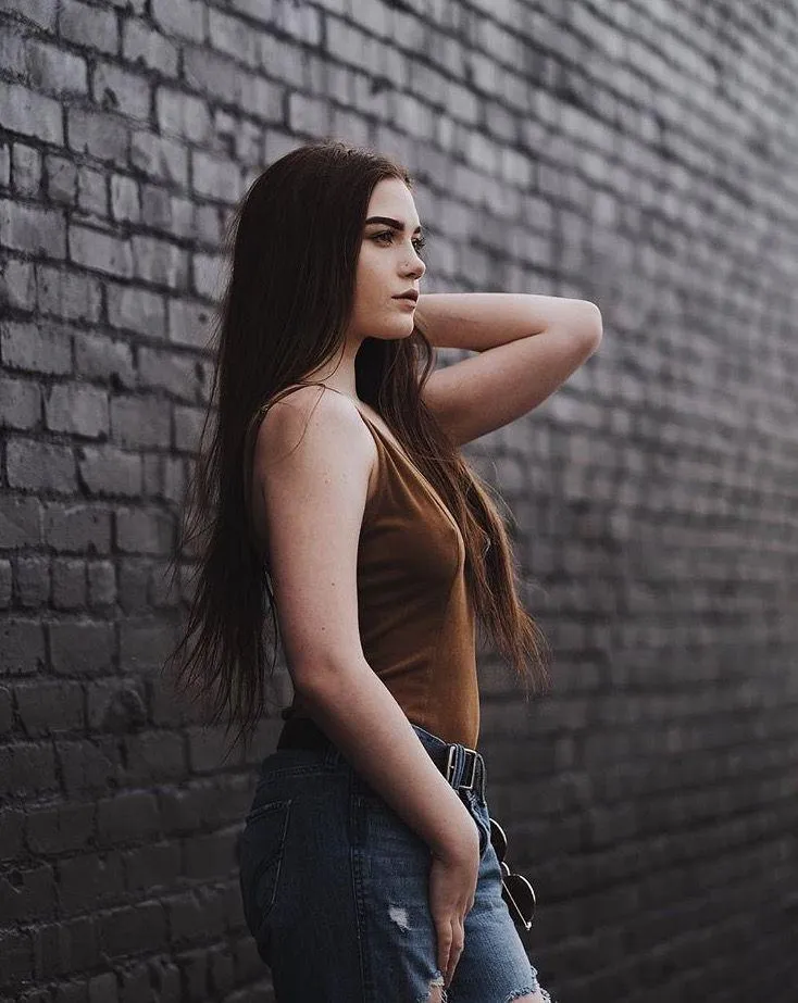 Woman Standing Confidently Beside a Sports Motorcycle Image