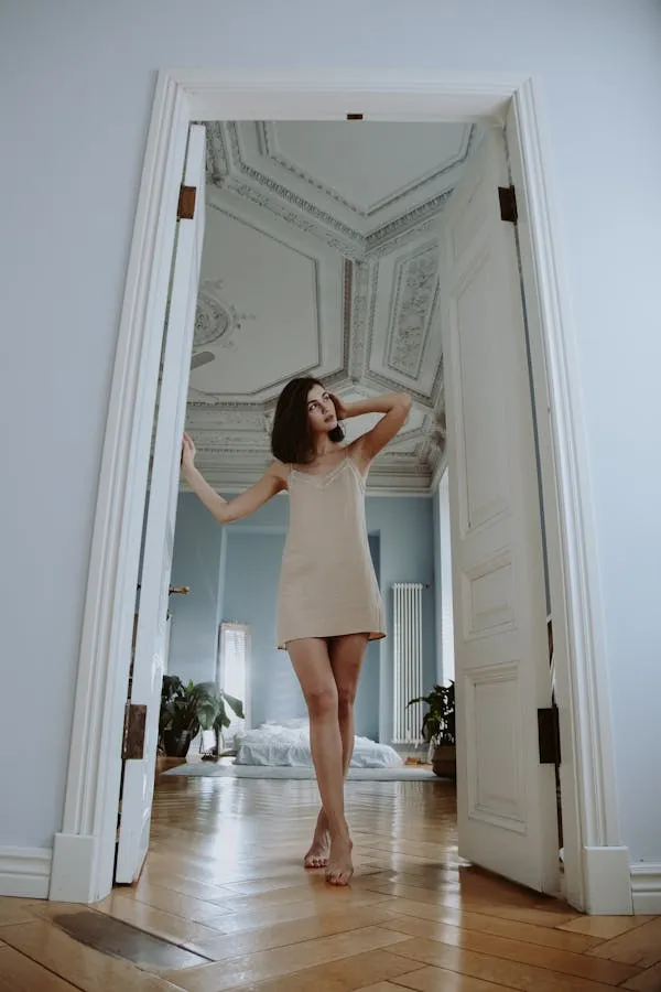 Woman Standing Confidently in a White Hallway Space Hd Image