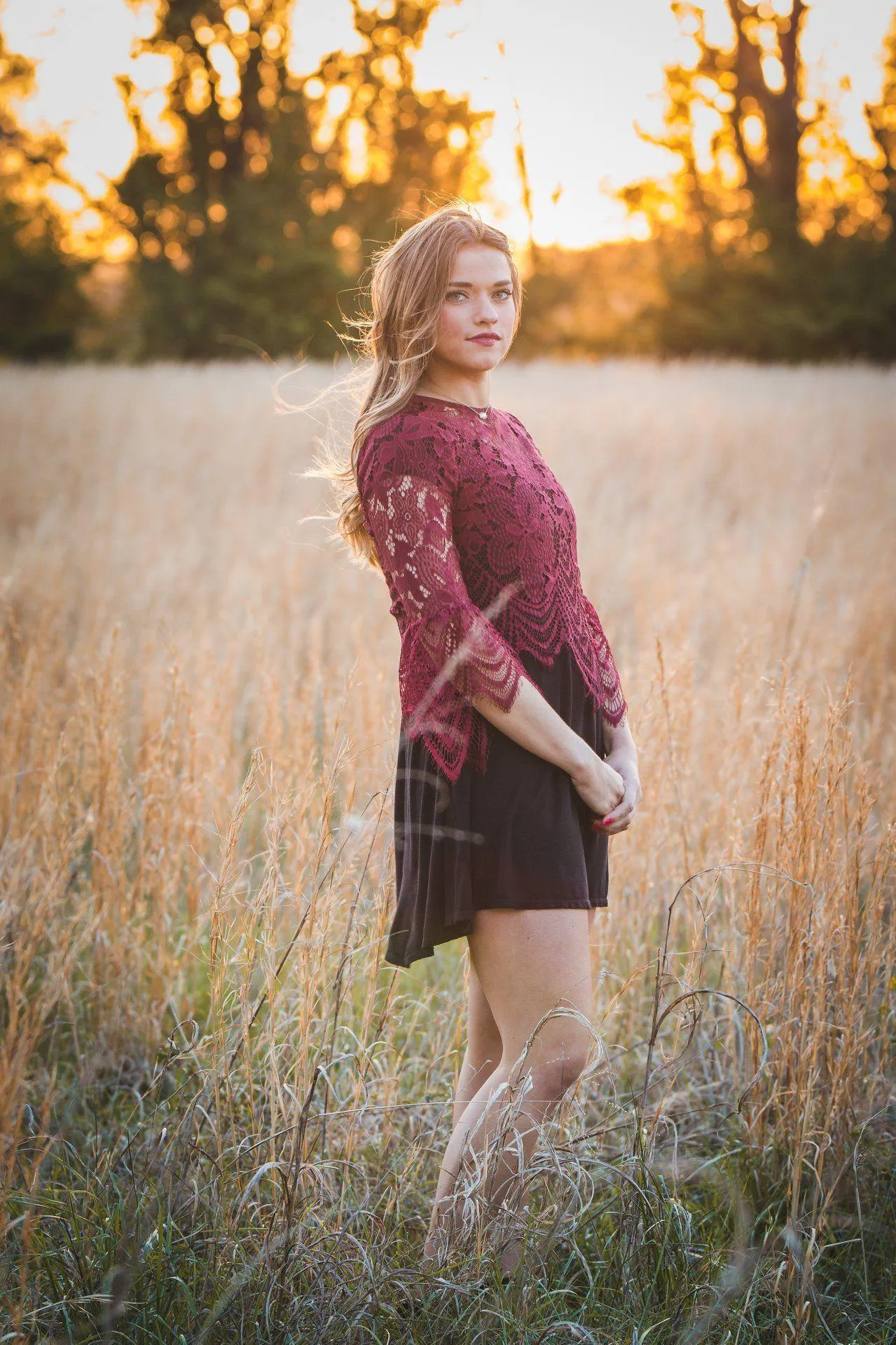 Woman Standing in a Field During Golden Hour with Warm Light