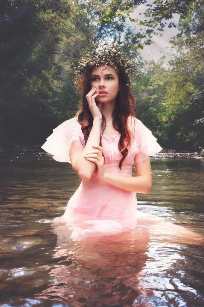 Woman Standing in a Forest Stream Wearing a Pink Dress Image