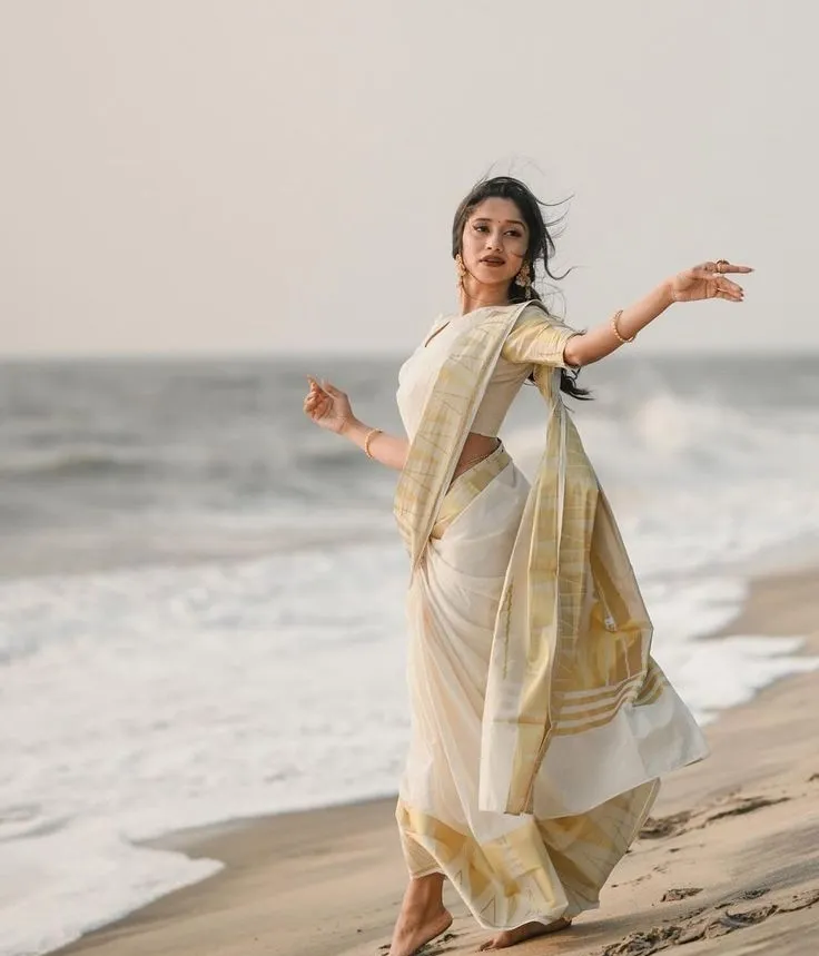 Woman standing on the beach with a dancing pose wallpaper
