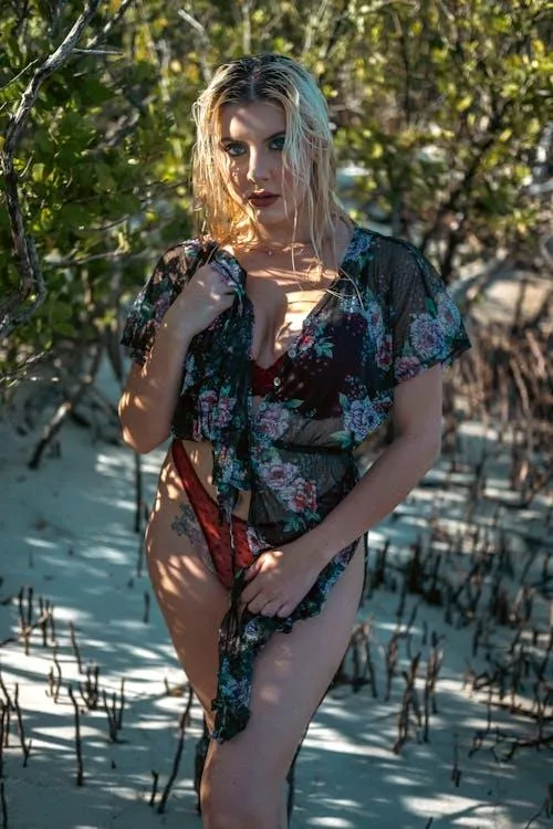 Woman Standing in Sunlight Wearing a Floral Summer Dress