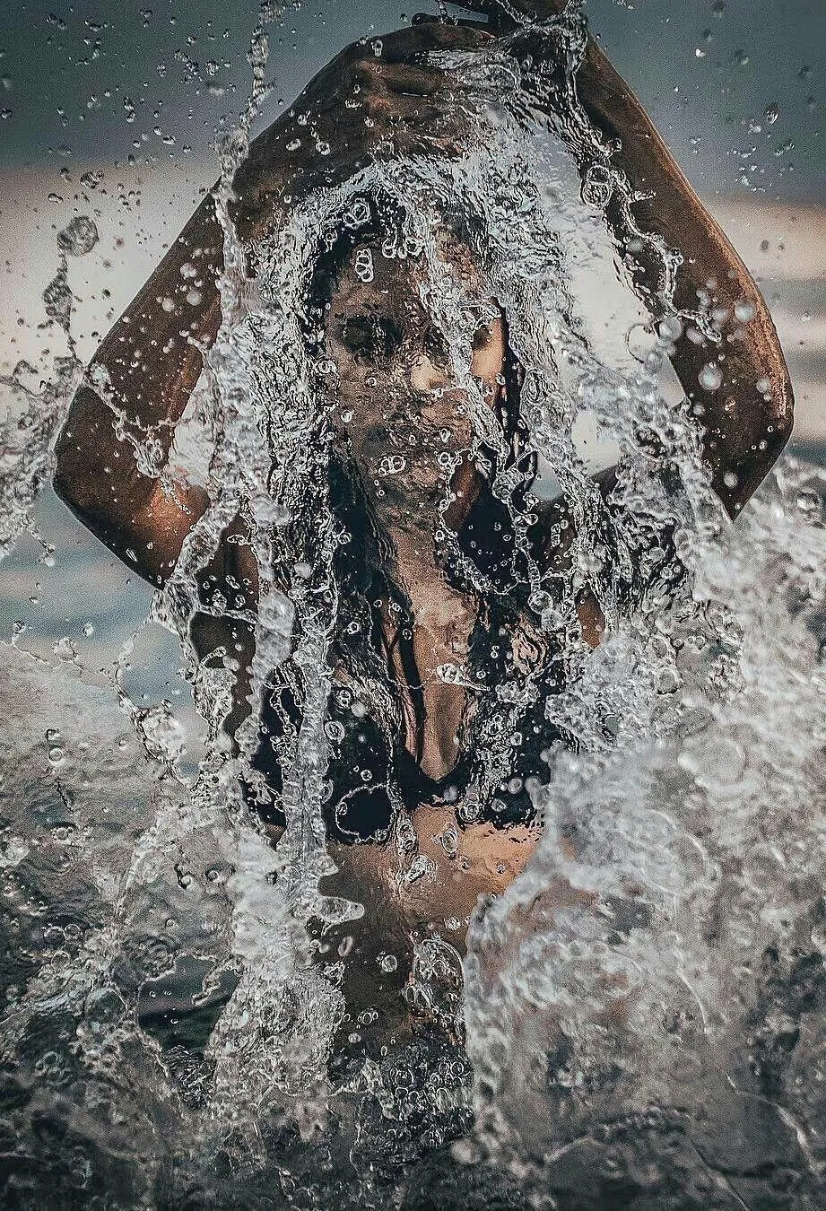 Woman Standing in the Water with Water Droplets Splashing