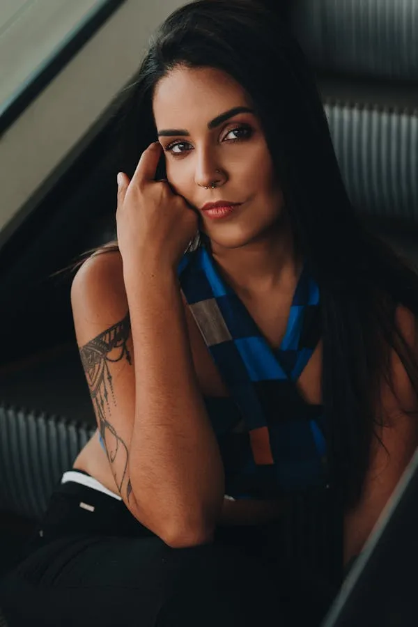 Woman with a Tattoo Looking At the Camera in Modern Setting