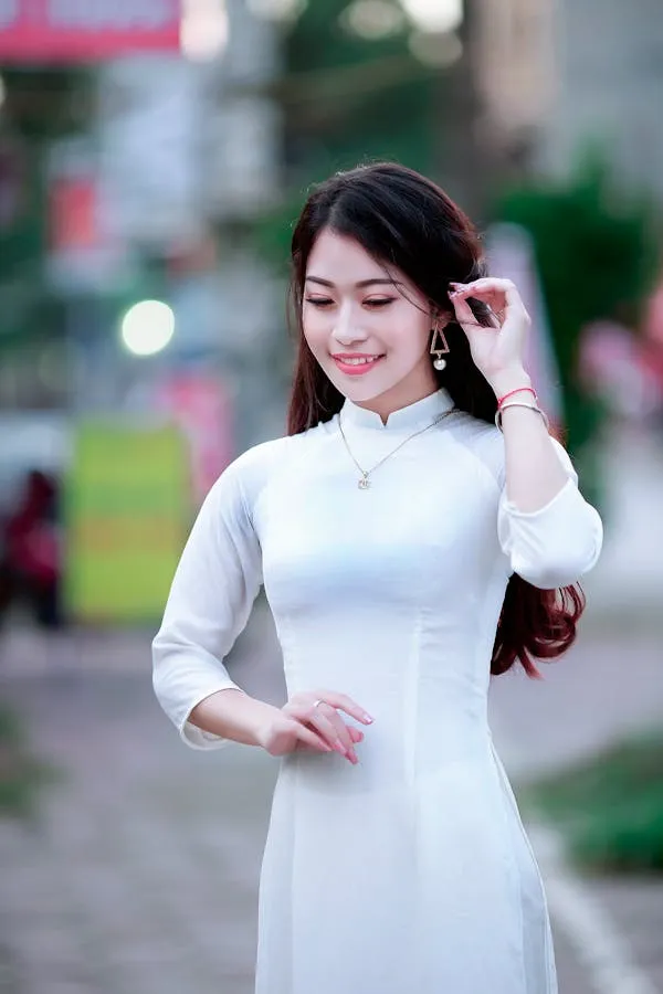 Woman in a Traditional White Dress with Cute Smile Wallpaper