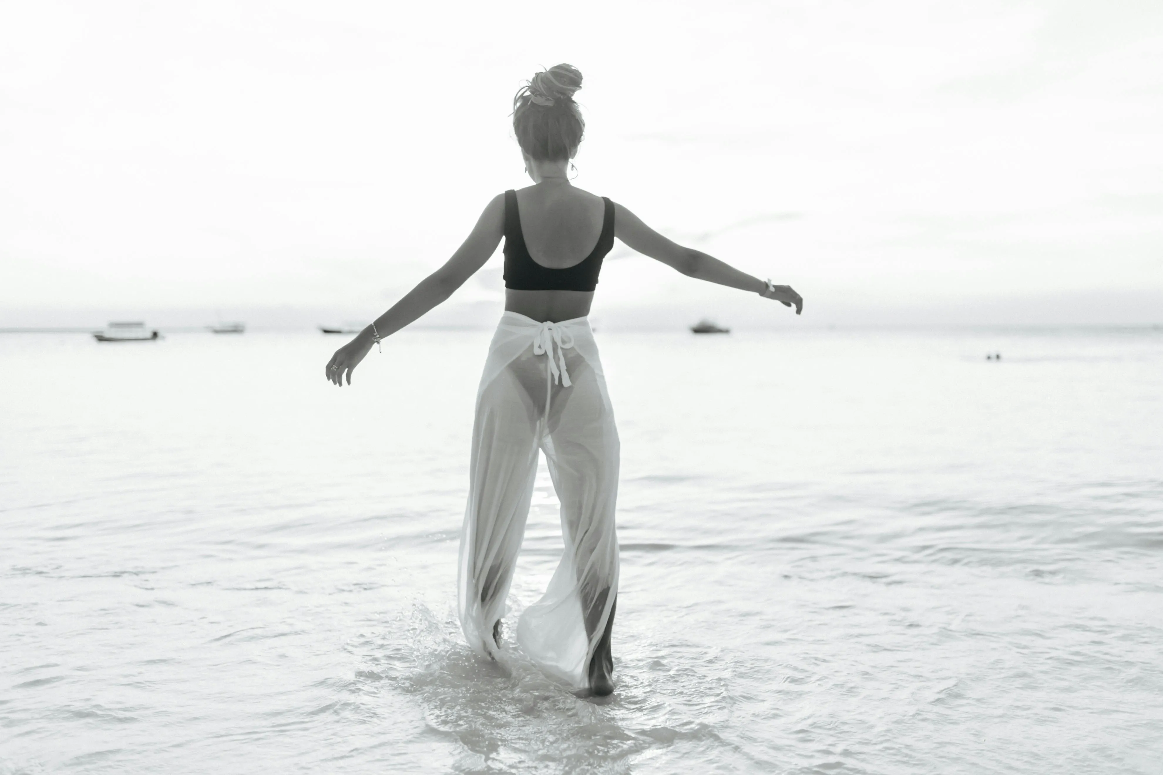 Woman Walking in the Sea with Her Arms Stretched Peacefully