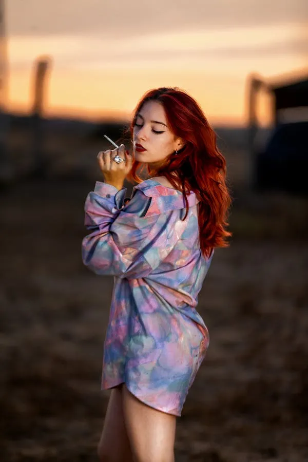 Woman Wearing a Colorful Jacket Looks Over Sunset Wallpaper