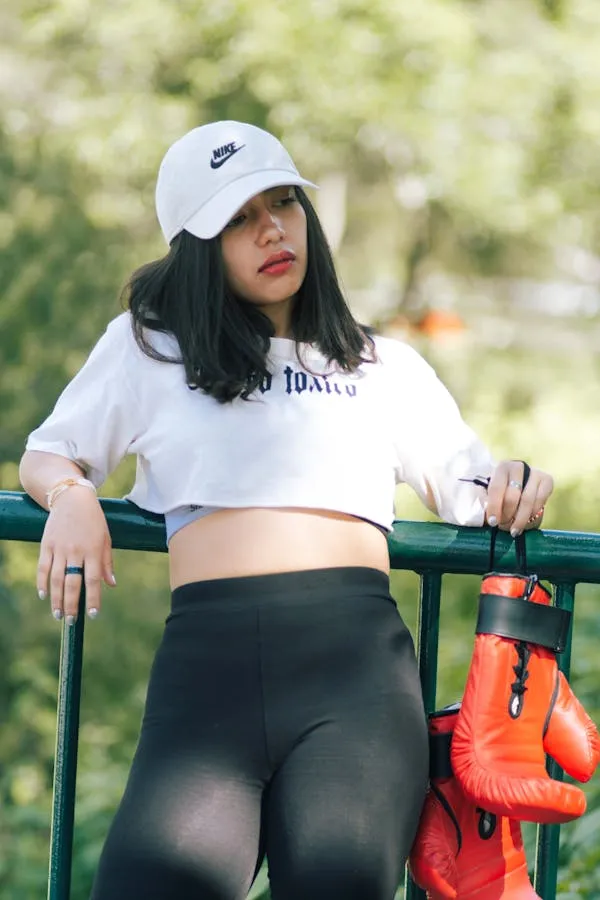 Woman in a White Crop Top and Baseball Cap Posing Outdoors