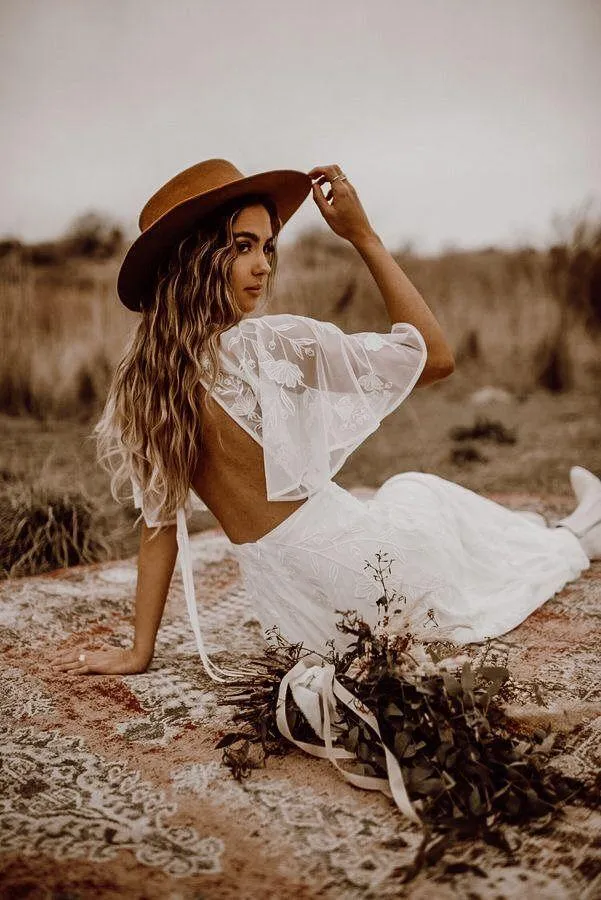 Woman in a White Dress Sitting in a Field with a Summer Hat