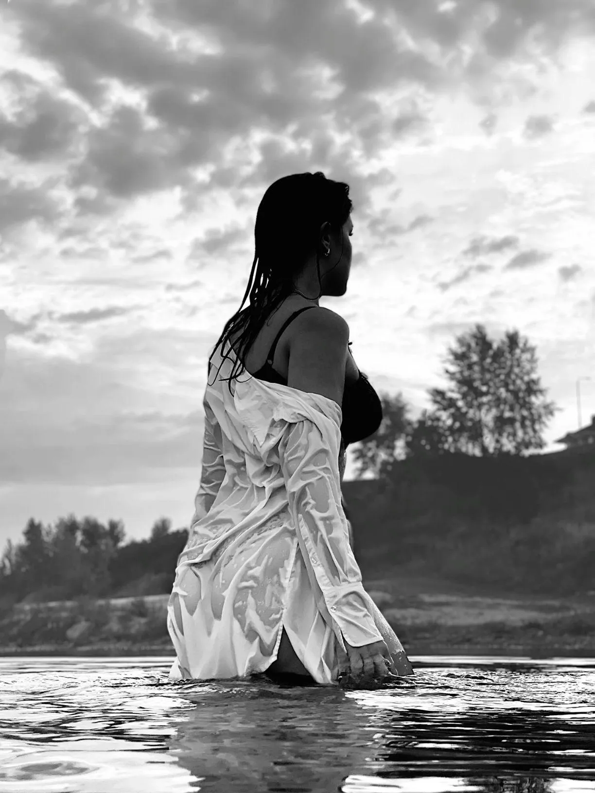 Woman in a White Dress Standing in Calm Reflective Water
