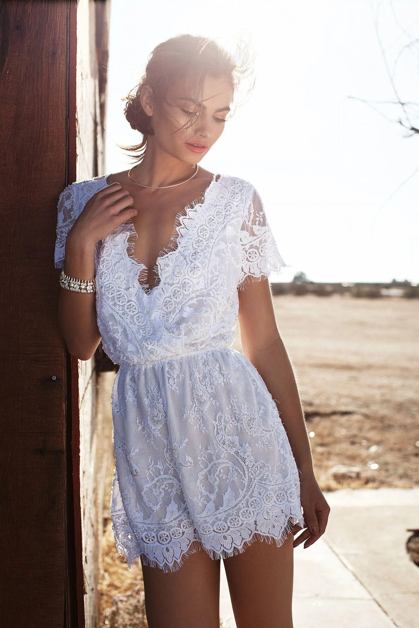 Woman in White Lace Dress Standing Outdoors in Natural Light